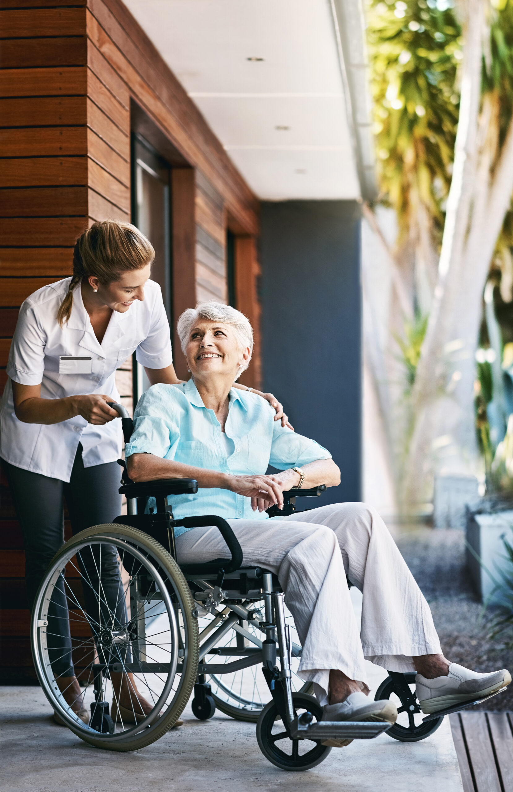 Whatever you need, Im here to help. a nurse caring for a senior patient in a wheelchair outside a retirement home. Caregiver help and care Asian senior or elderly old lady woman patient sitting on wheelchair to ramp in nursing hospital, healthy strong medical concept.